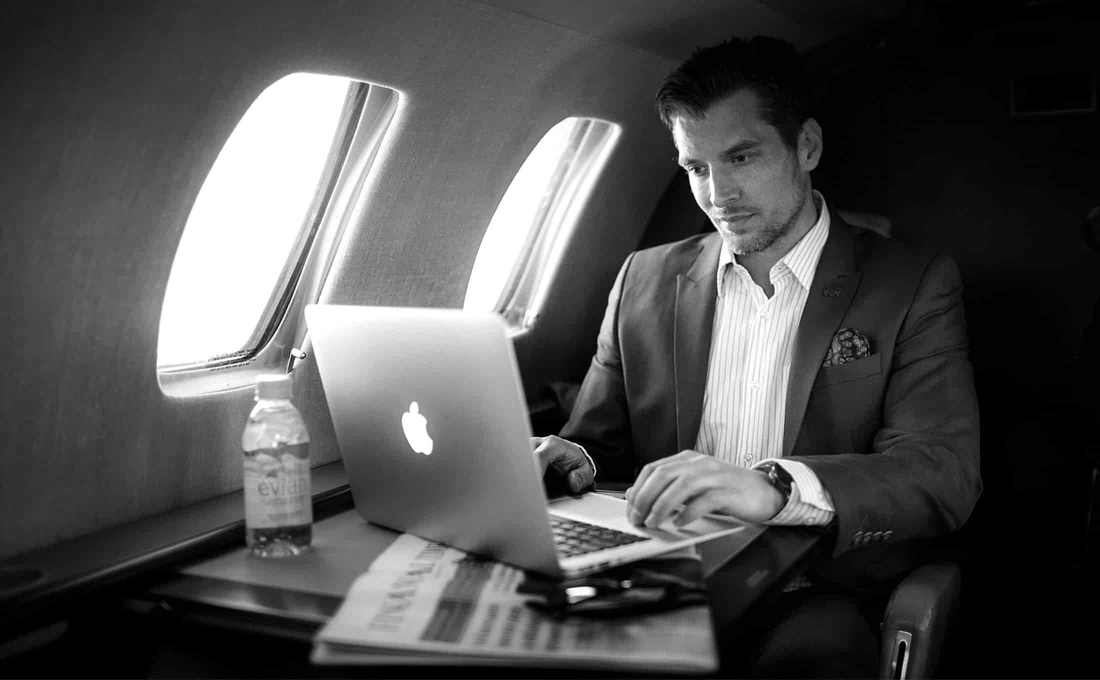 Client With Laptop Travelling In Sigma Elite Airplane