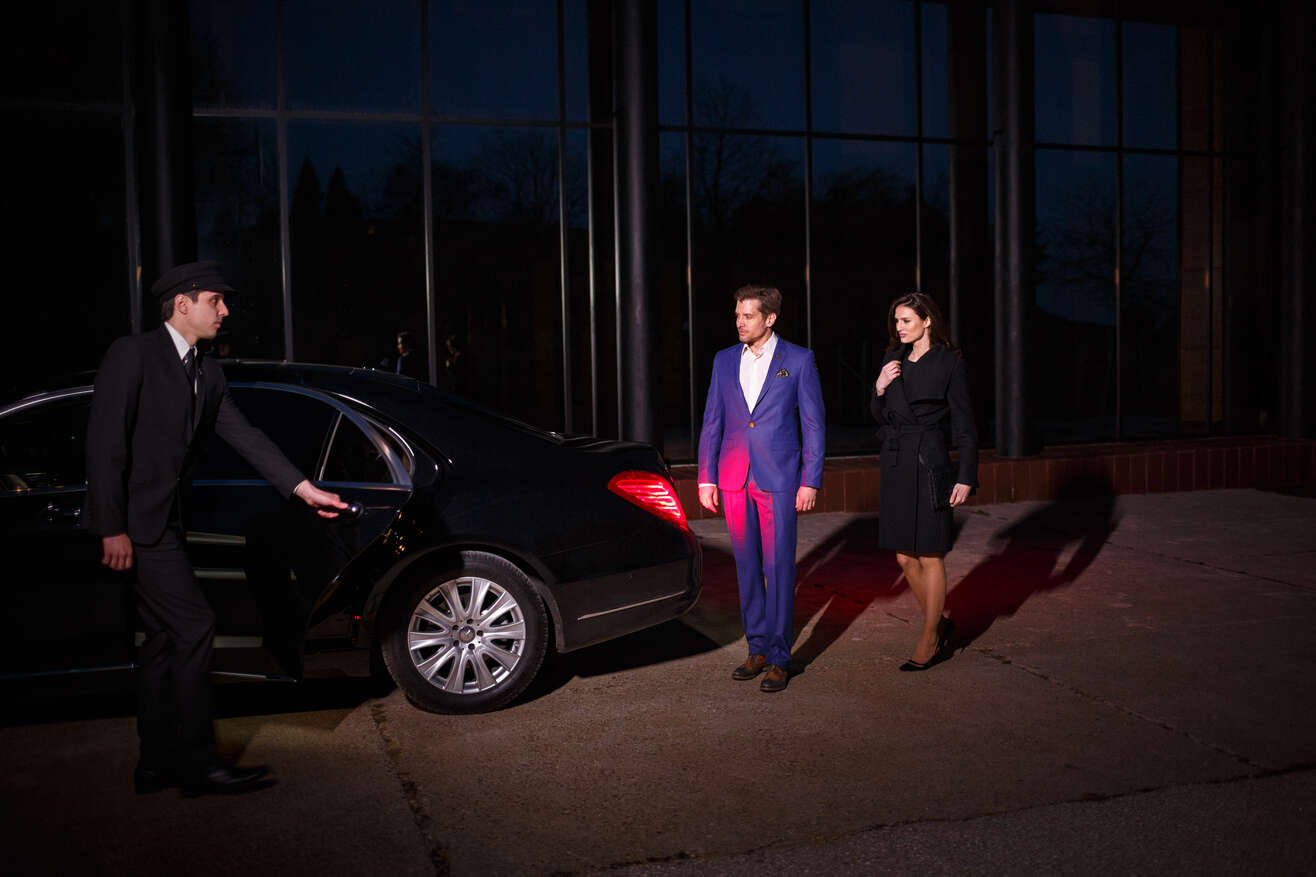 Sigma Chauffeur And Concierge Opening Limo Door For Clients