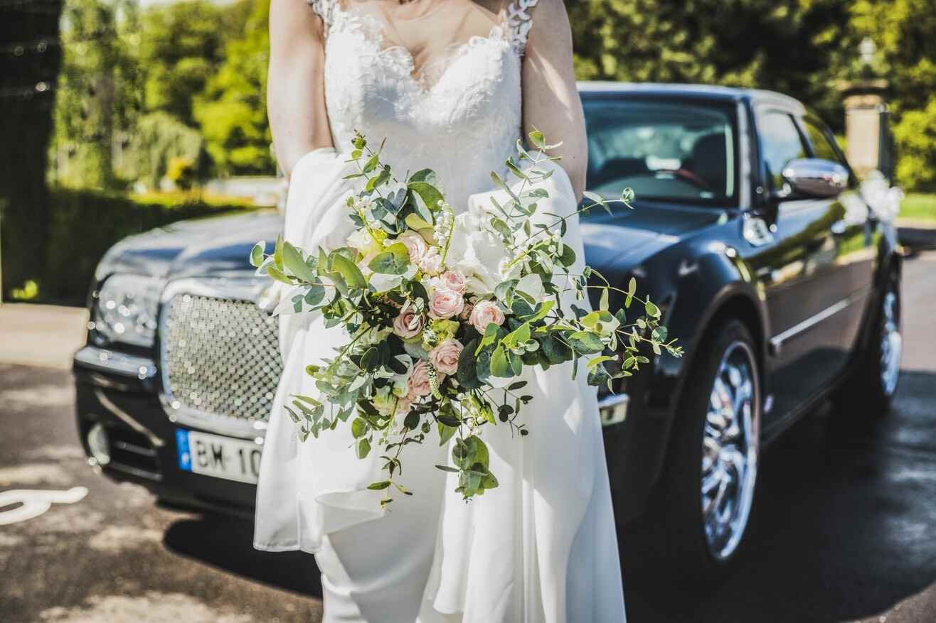 Bride standing in front of the limo
